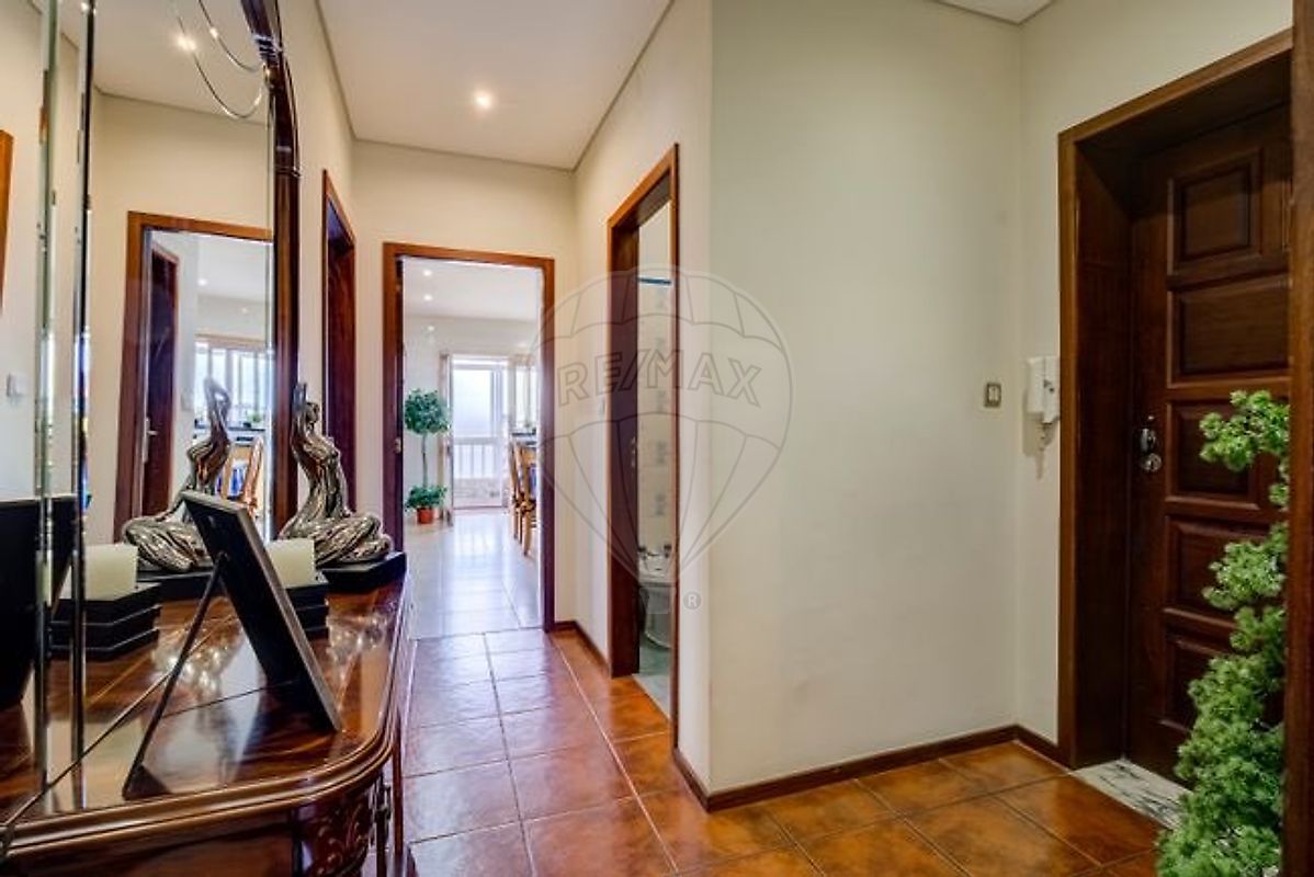 Corredor de distribuição interna do apartamento T3 com espelho decorativo