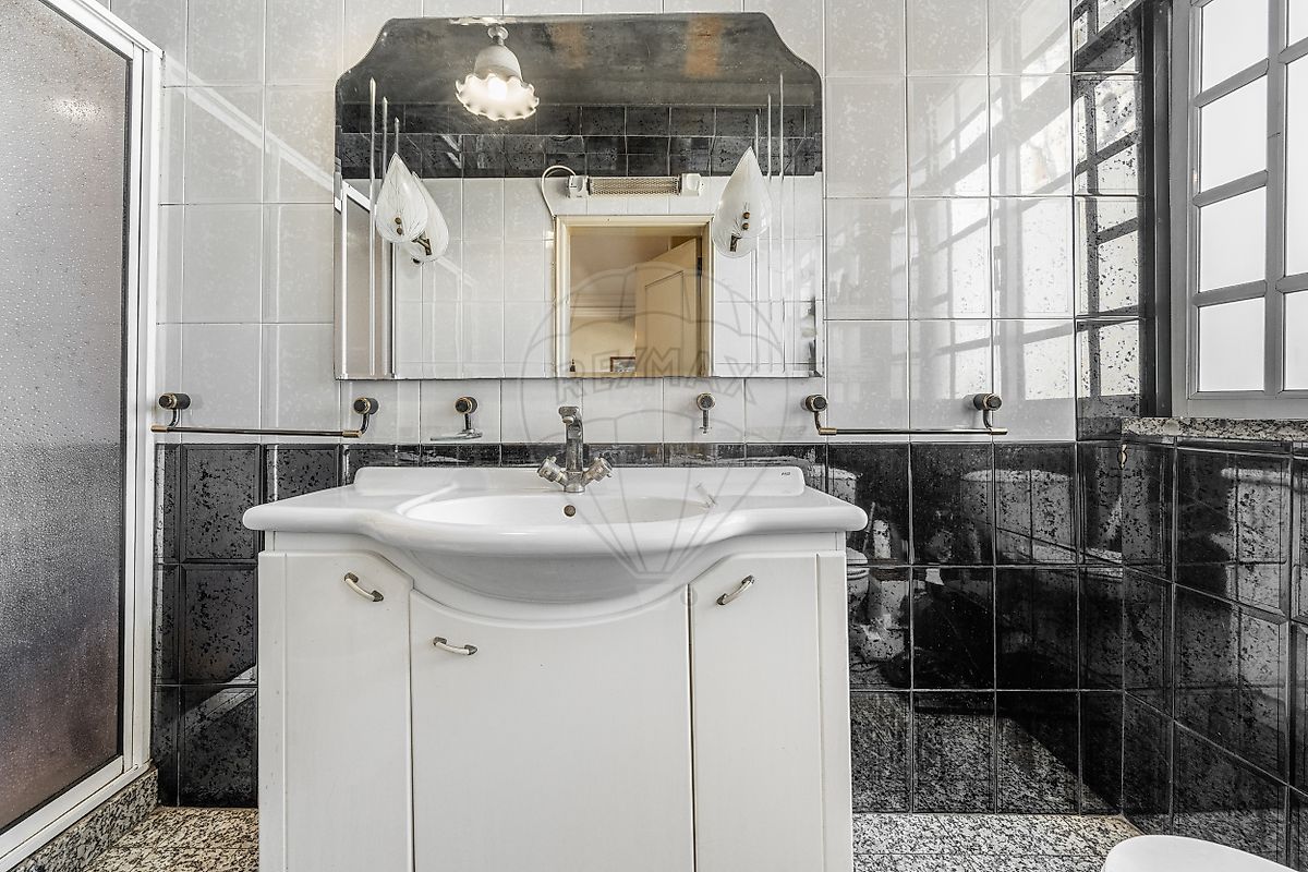 Casa de banho com banheira e teto inclinado em madeira em moradia T3 Fafe